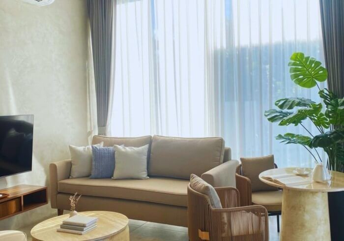 A living room with a couch , chairs , table and television.