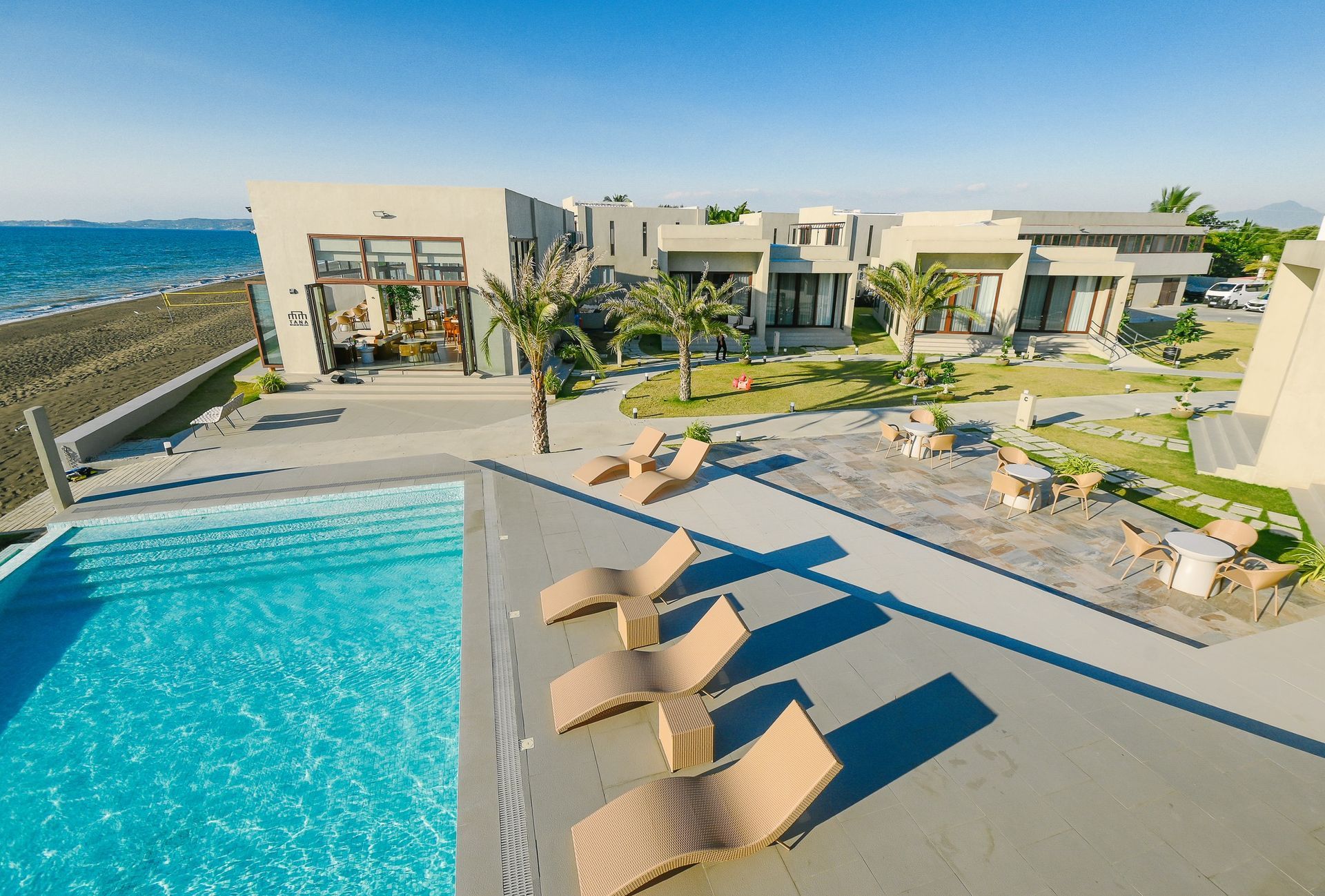 An aerial view of a swimming pool with chairs around it