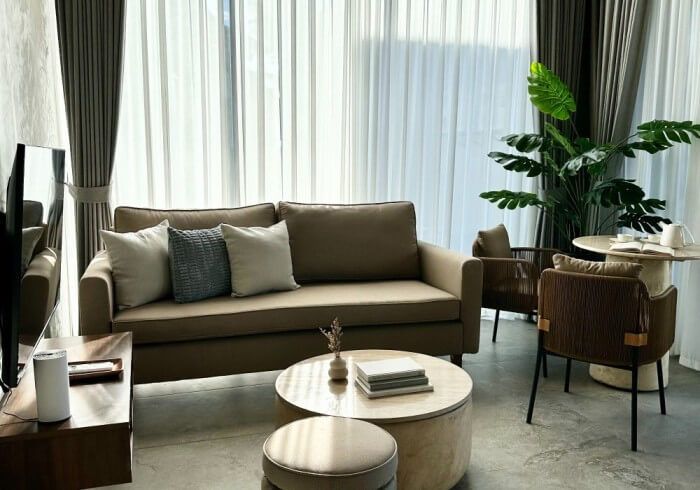 A living room with a couch , table , chairs and a television.