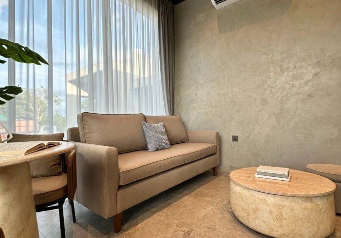 A living room with a couch , table and chairs.