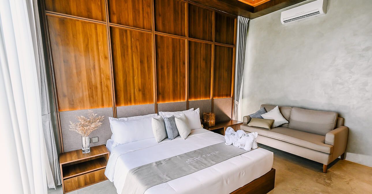There is a bed and a couch in the room.