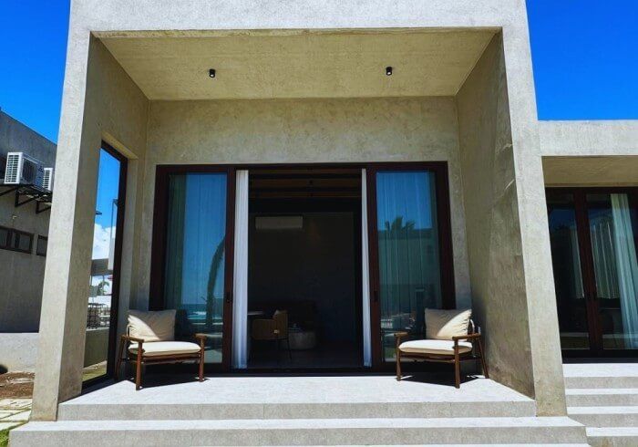 A house with two chairs and a sliding glass door