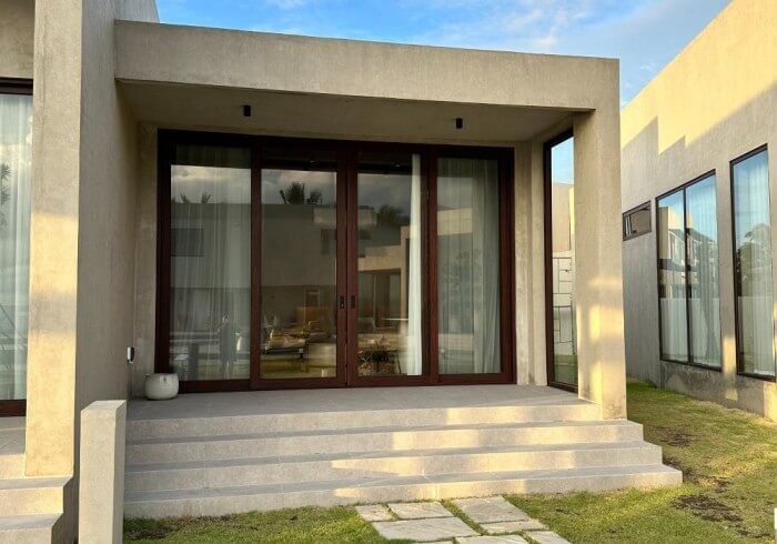 A house with a lot of windows and sliding glass doors