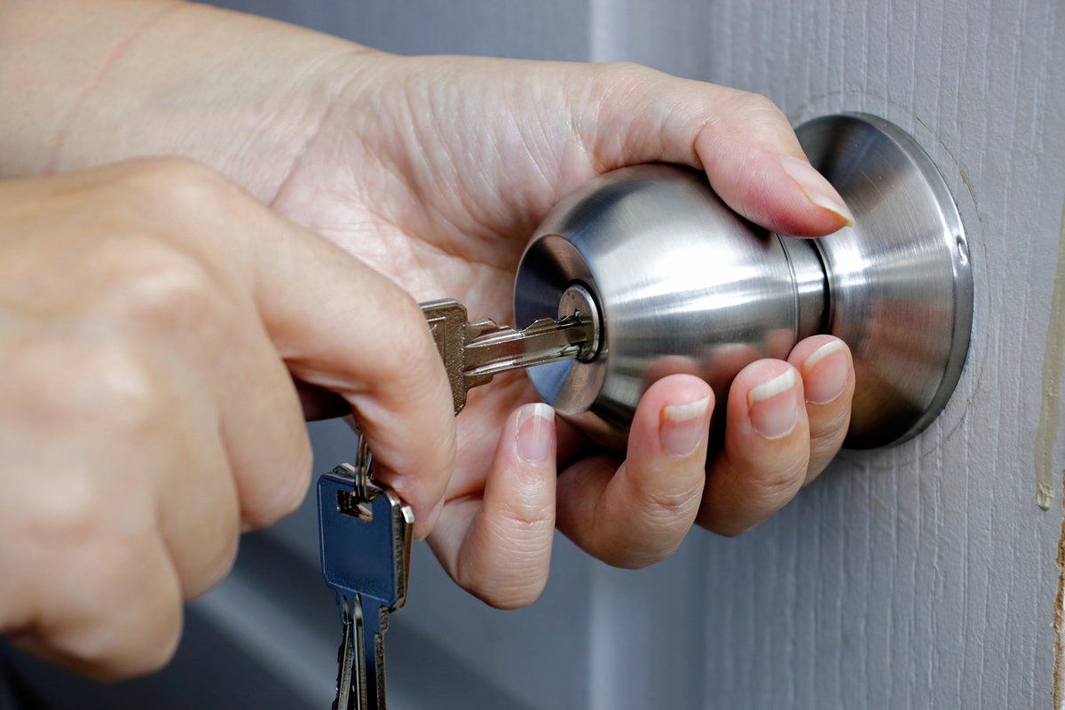 Unlocking door with a key — Chicago, IL — Ace Lock & Key Smith Unlocking door with a key — Chicago, IL — Ace Lock & Key Smith
