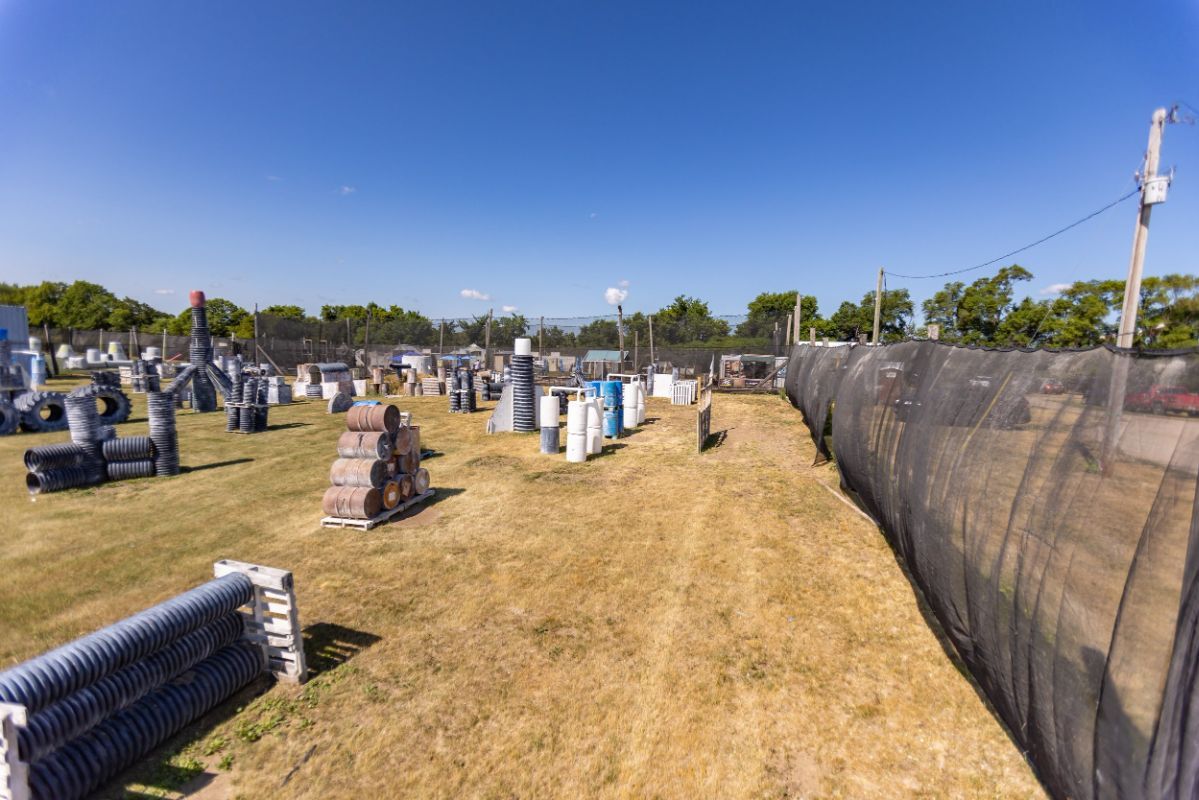 An aerial view of a paintball field with a fence surrounding it.
