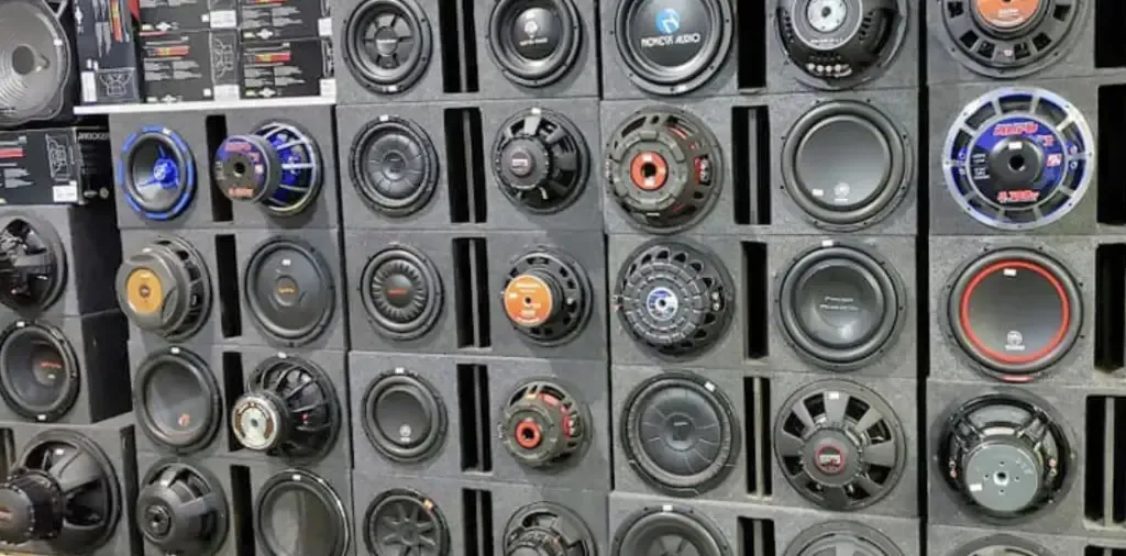 A wall filled with lots of different types of speakers.