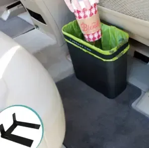 A trash can with an umbrella in it that says bride