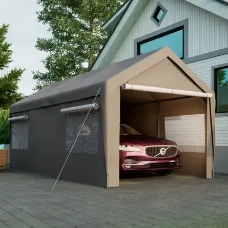A car is parked under a tent in front of a house