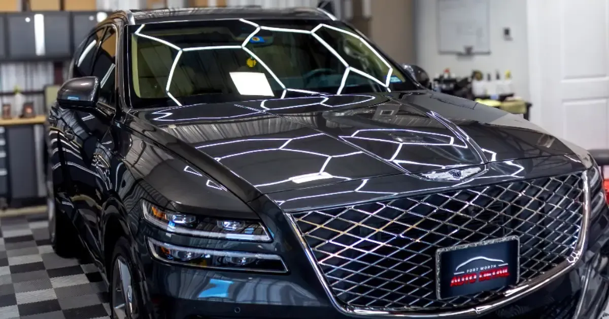 A black car is parked in a garage.