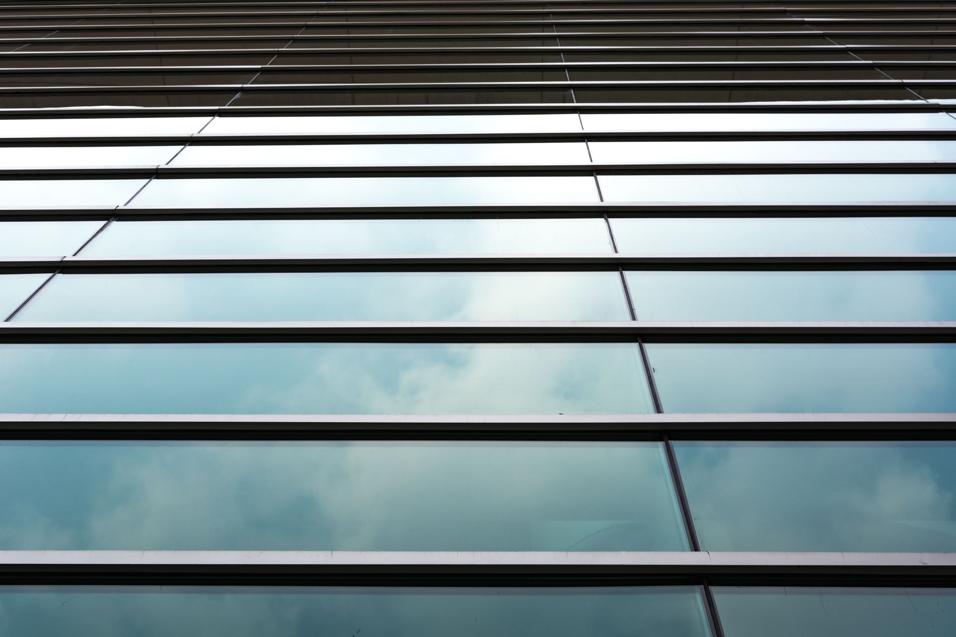 The sky is reflected in the windows of a building.