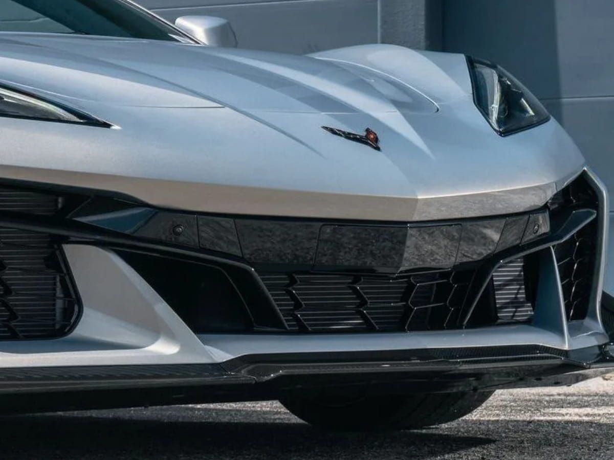 Close-up of the front bumper and hood of a silver Chevrolet Corvette C8.