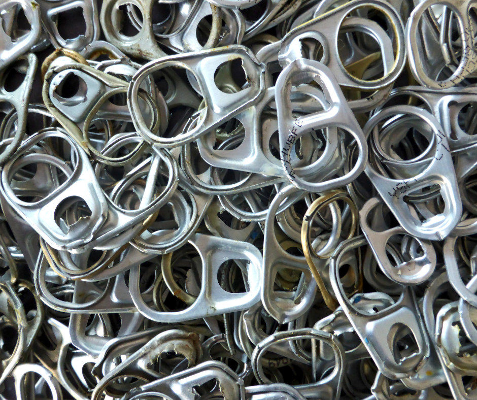 Pile of silver aluminum can pull tabs stacked closely together