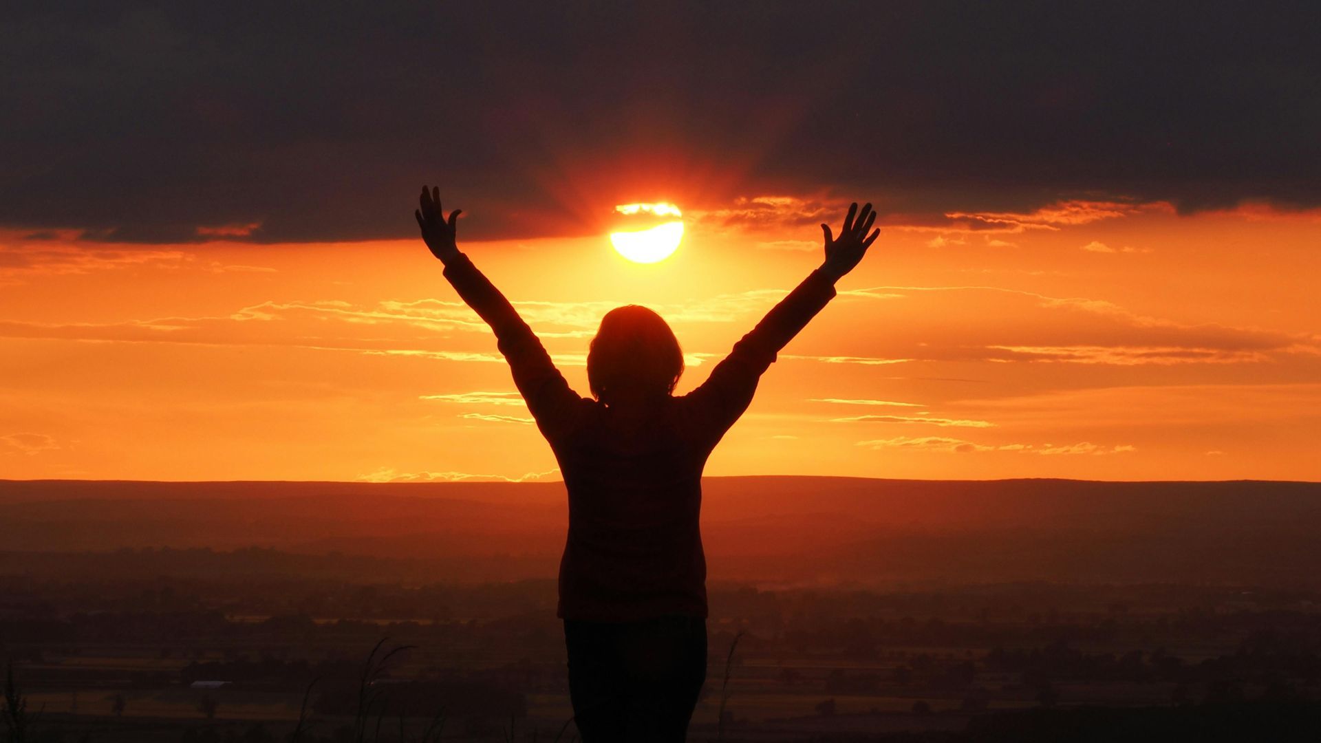 woman in front of sunset