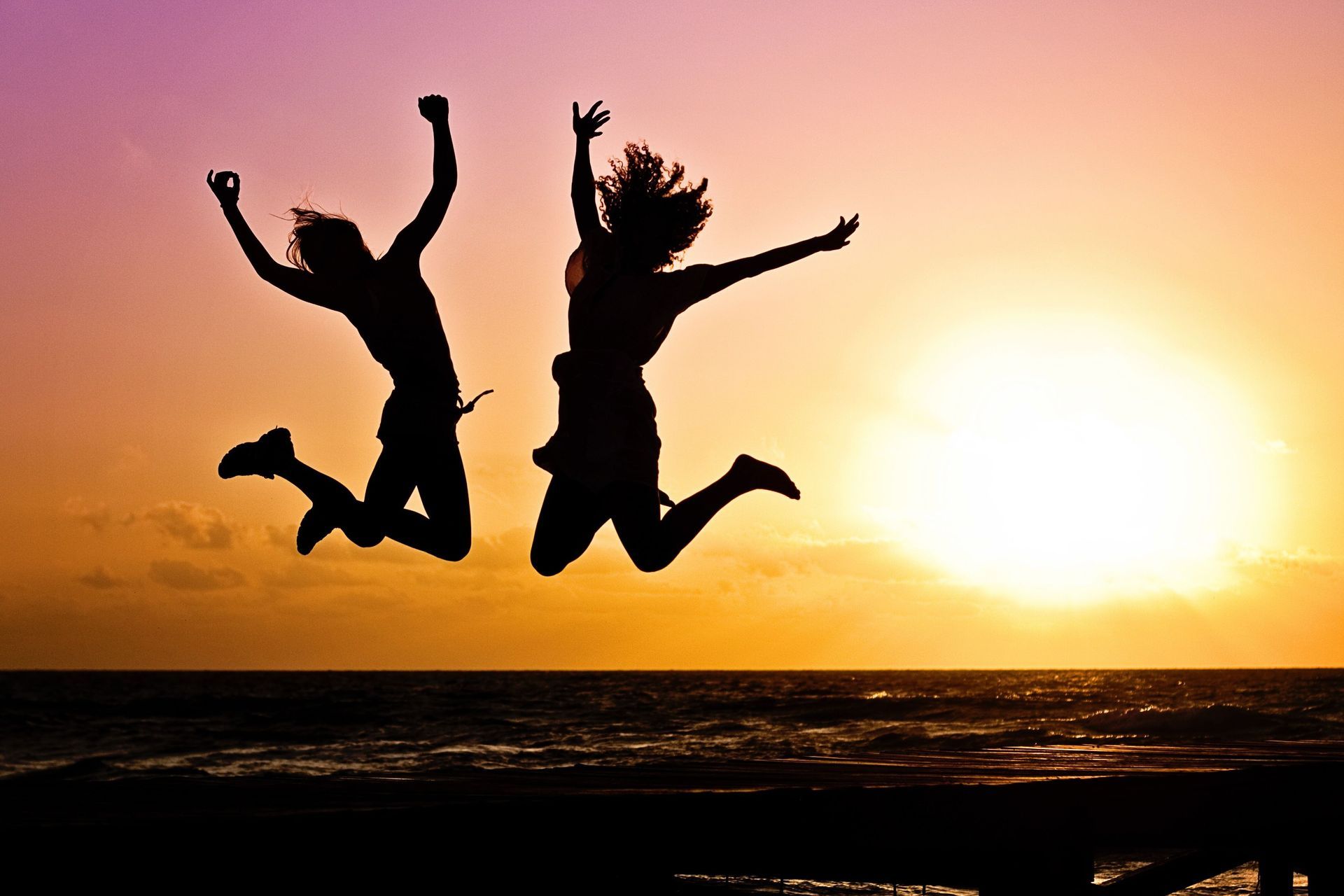 Two people jumping for joy