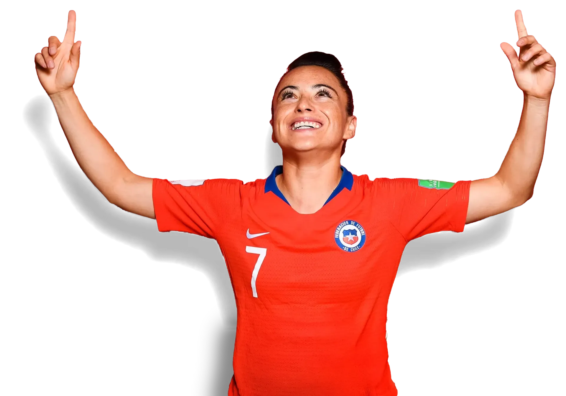 Soccer player in red jersey with arms raised and pointing upward, smiling against a white background