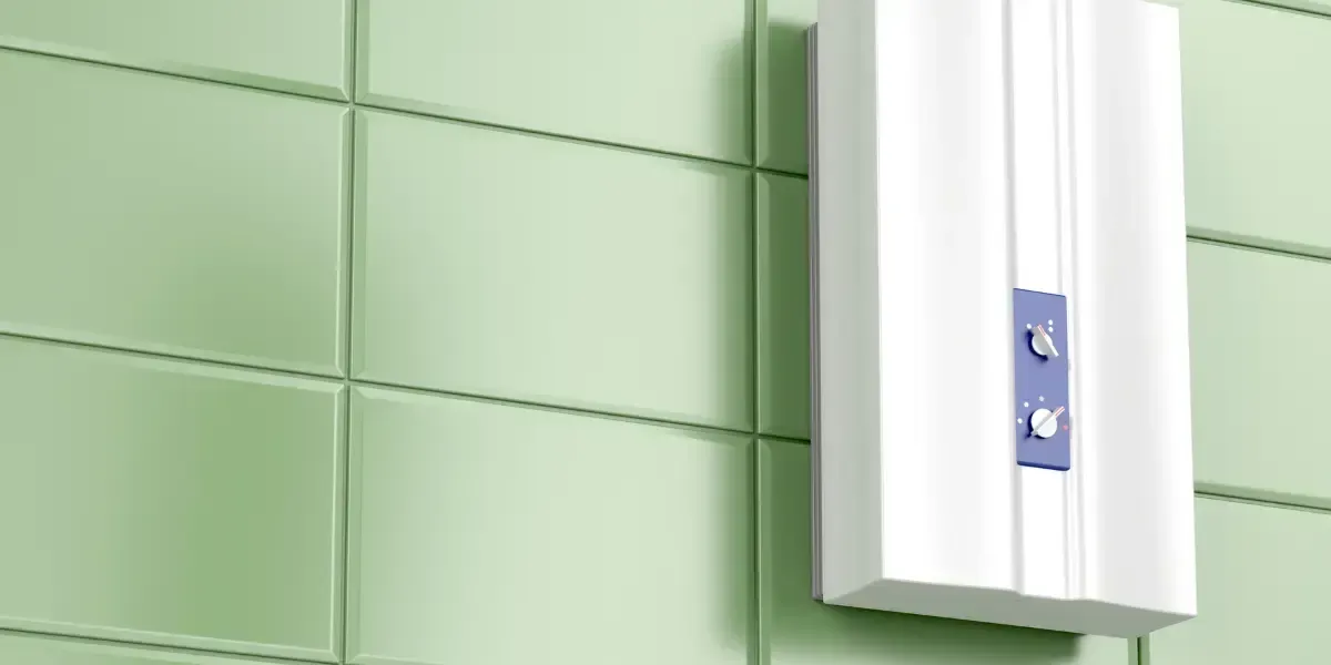 A white water heater is hanging on a green tiled wall.