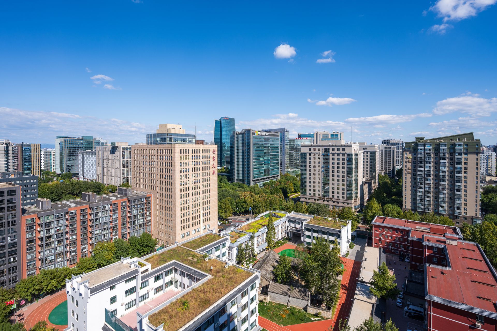 An aerial view of a city with lots of buildings and trees.
