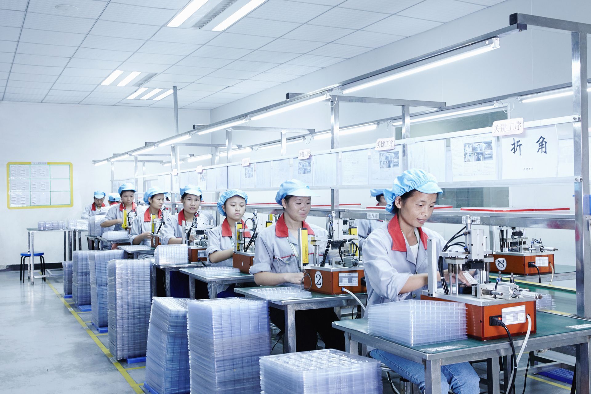 A group of people are working in a factory.
