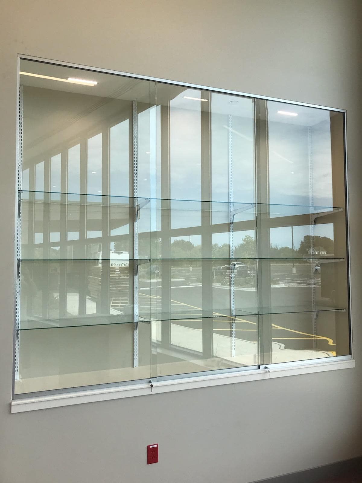 A large window with a glass display case behind it