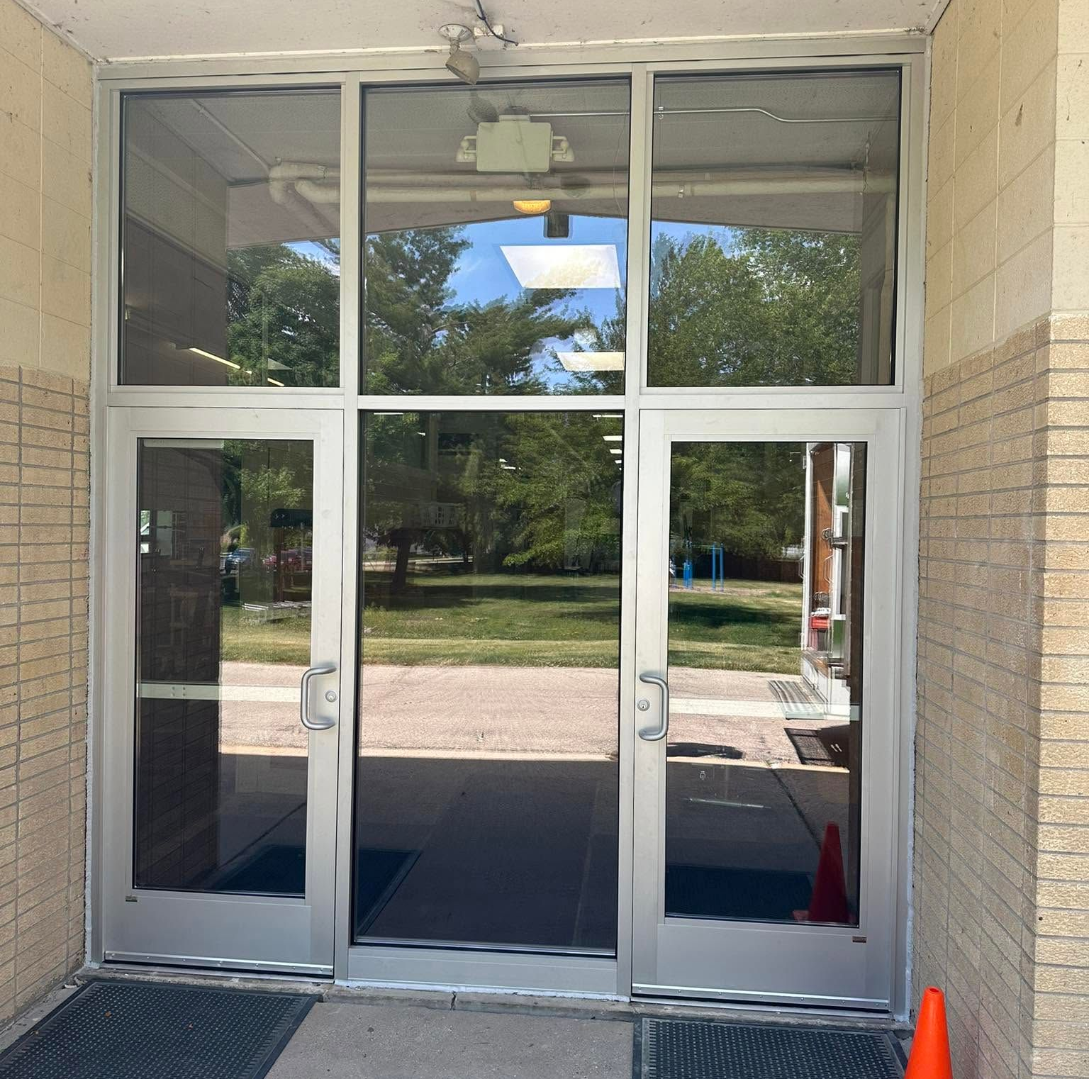 Aluminum commercial double glass door installation at a Janesville, WI building entrance