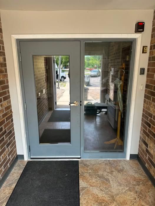 Aluminum double glass doors with transom windows installed at a commercial building in Janesville, WI