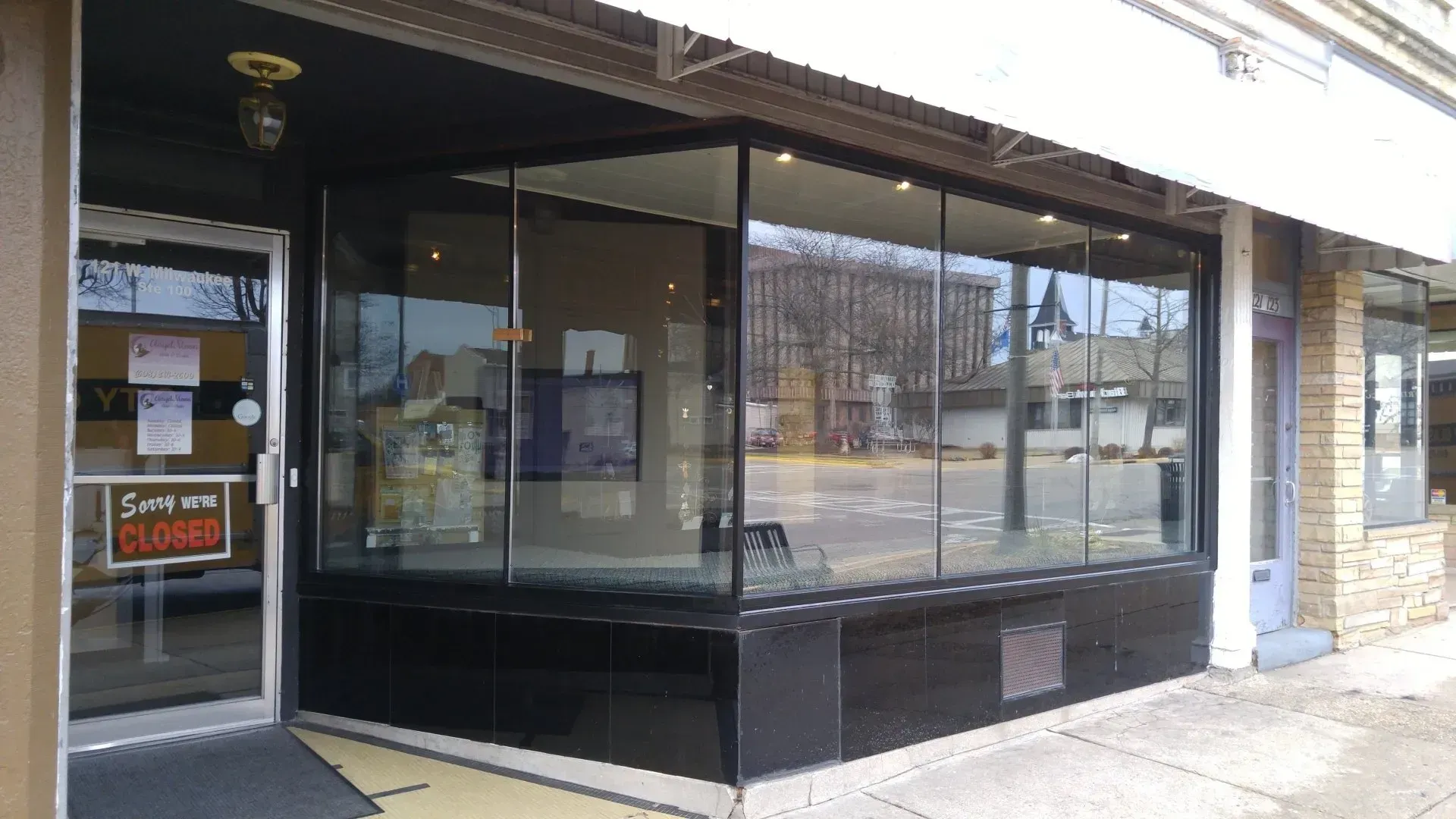 A store front with a sign that says sorry we are closed