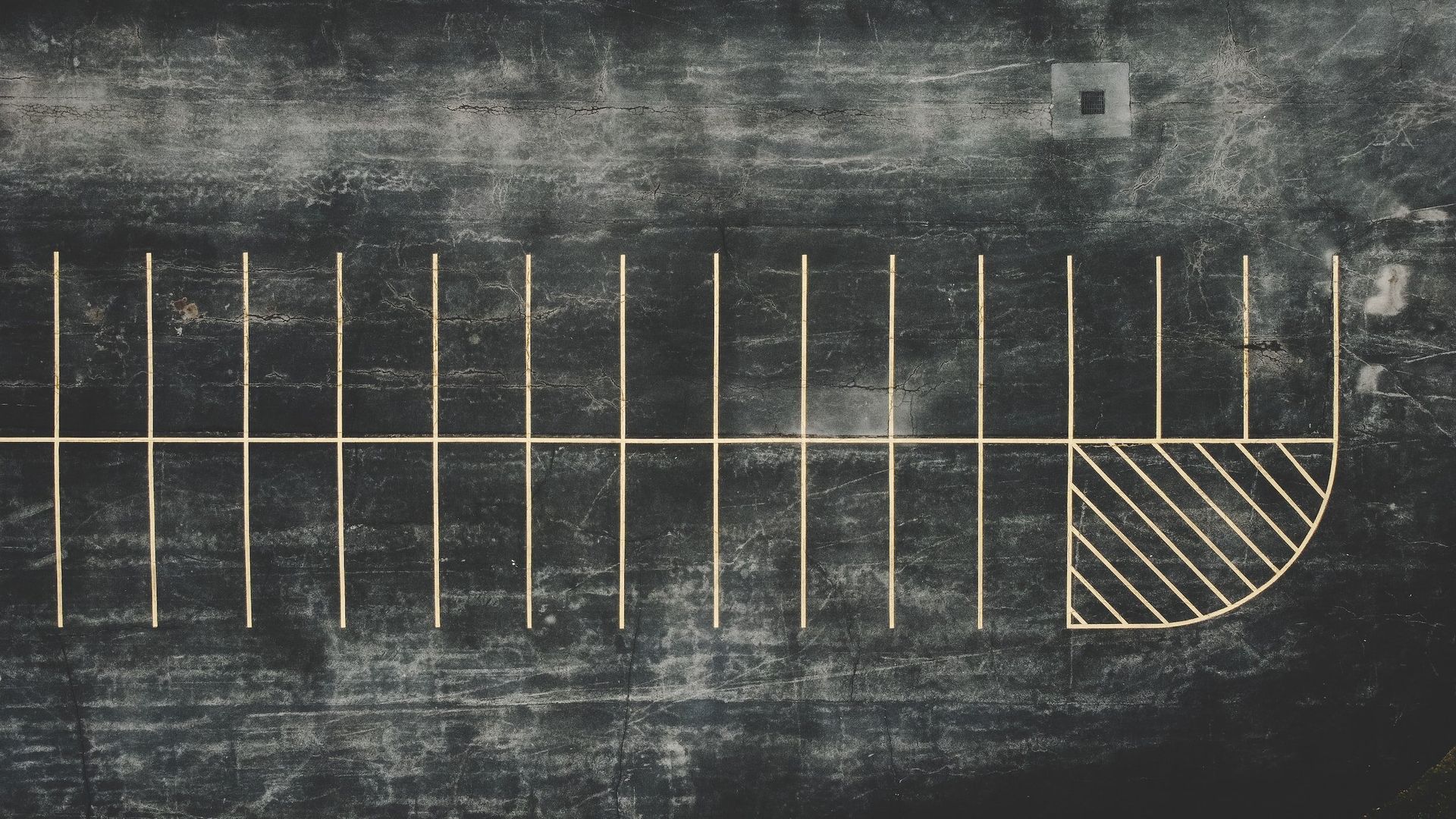 Chalkboard-style parking lot diagram with marked stalls and a hatched accessible parking space at the end