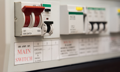 Electrical fuse box with switches labeled 