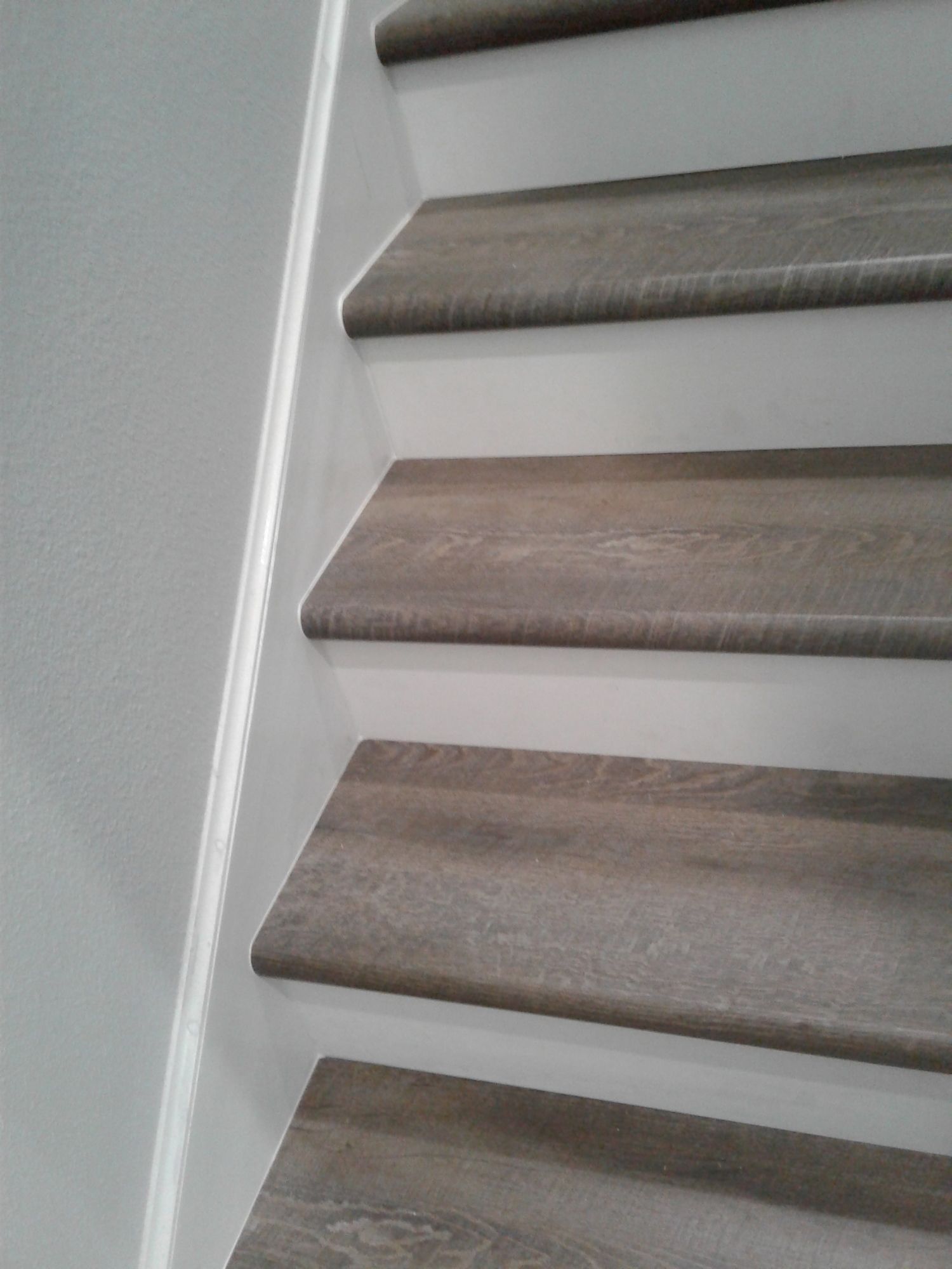 a close up of a set of stairs with wooden steps .