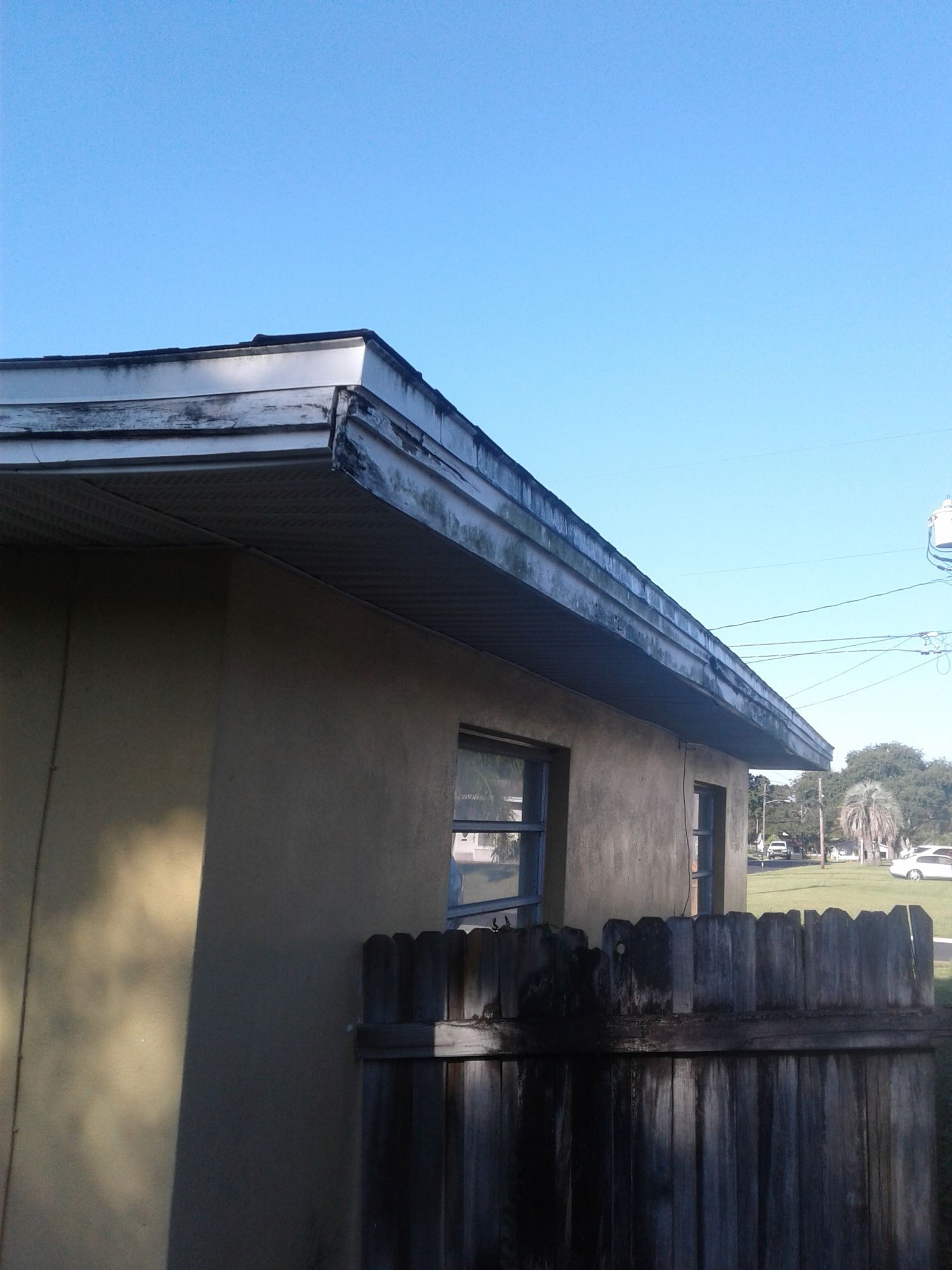 a house with a wooden fence in front of it