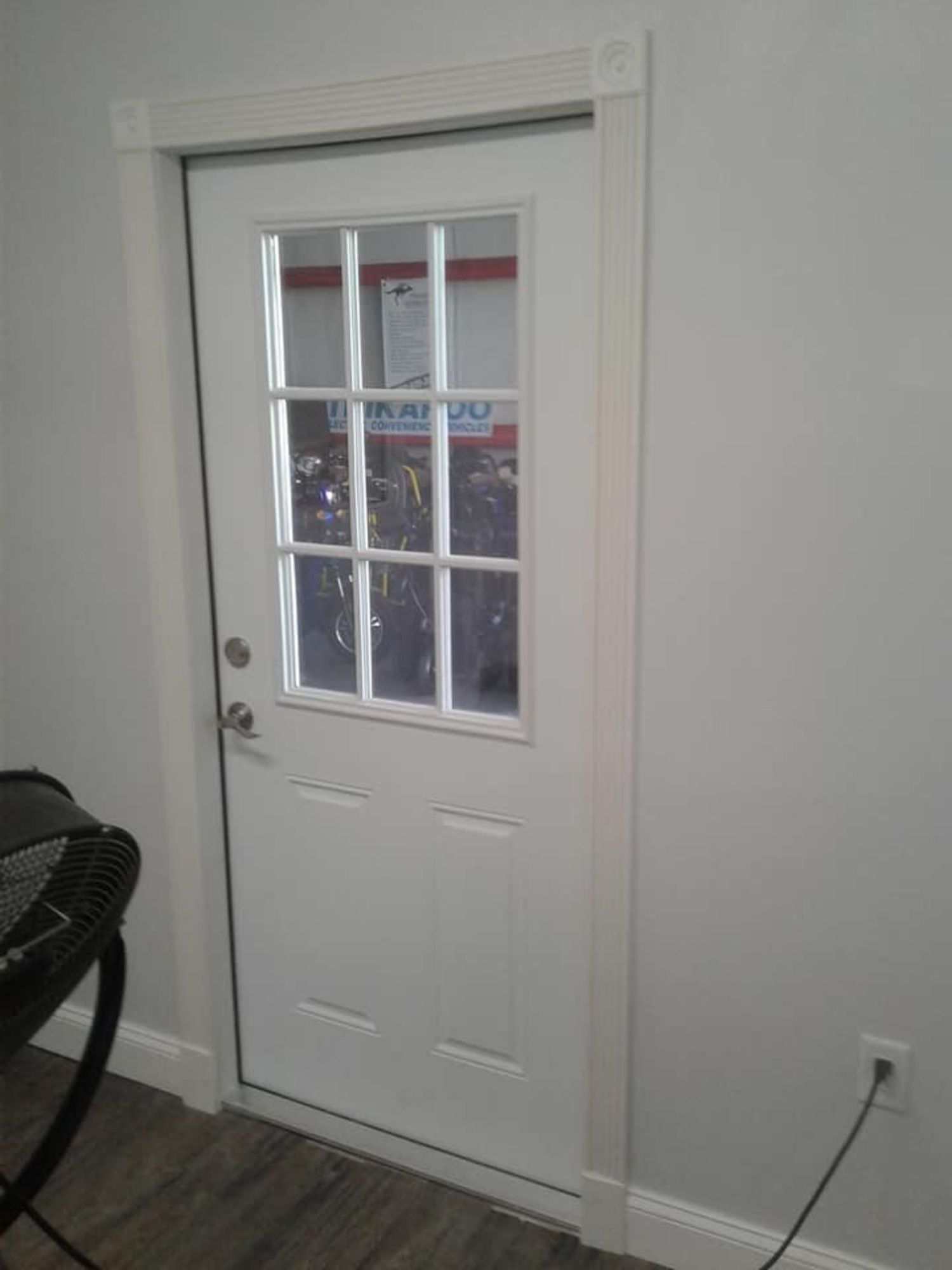 a white door with a window in a room .