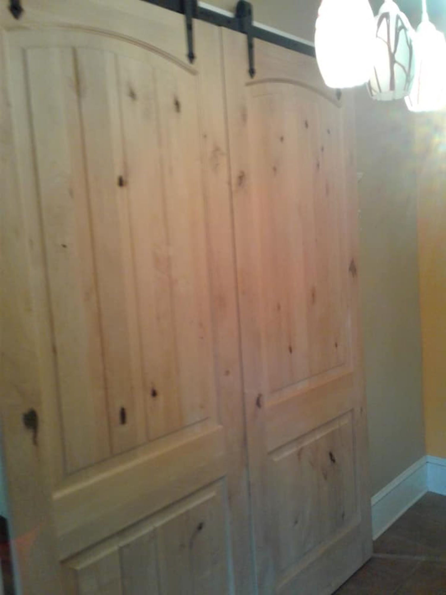 a pair of wooden sliding barn doors in a hallway