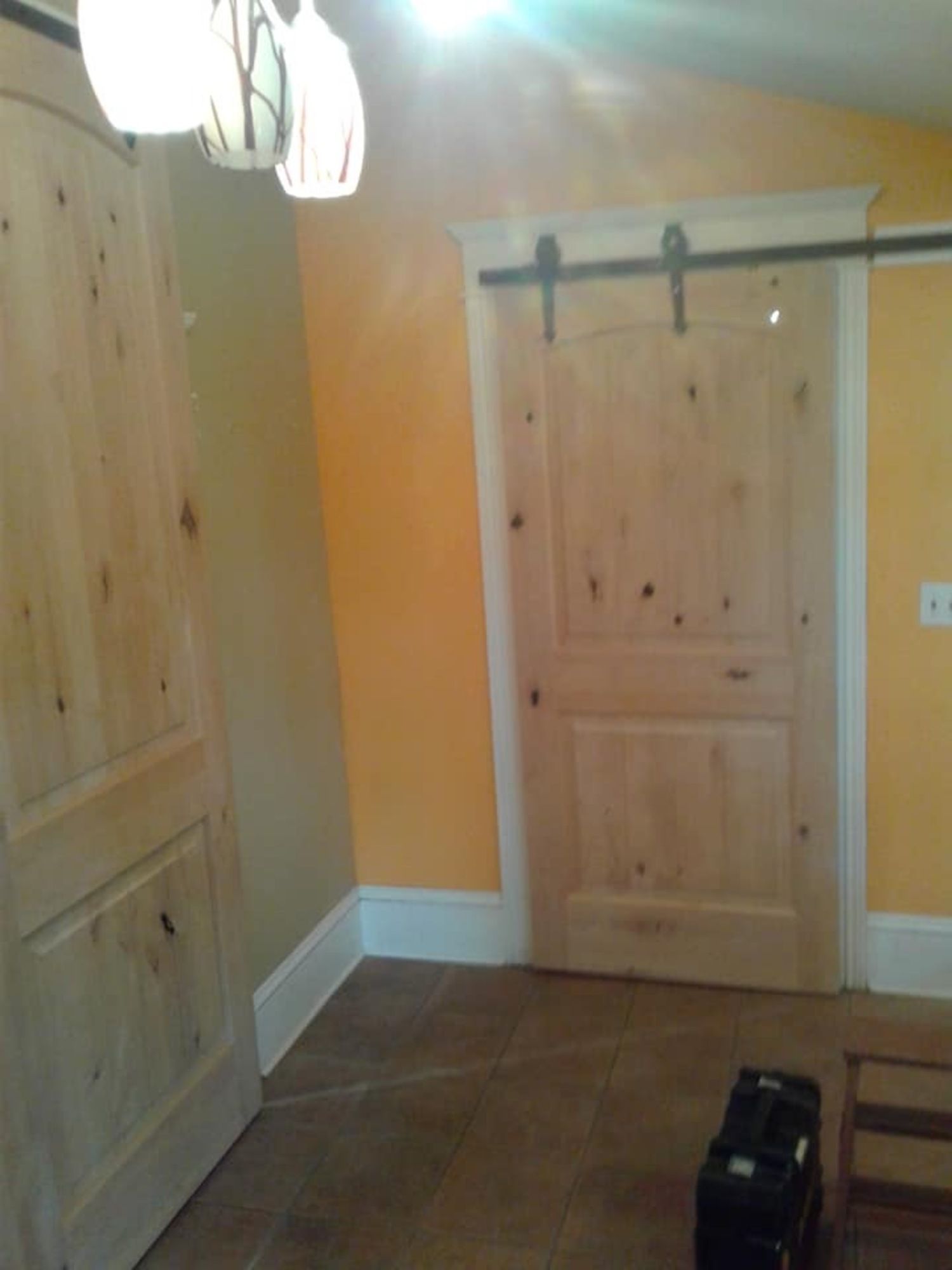 an empty room with a sliding barn door