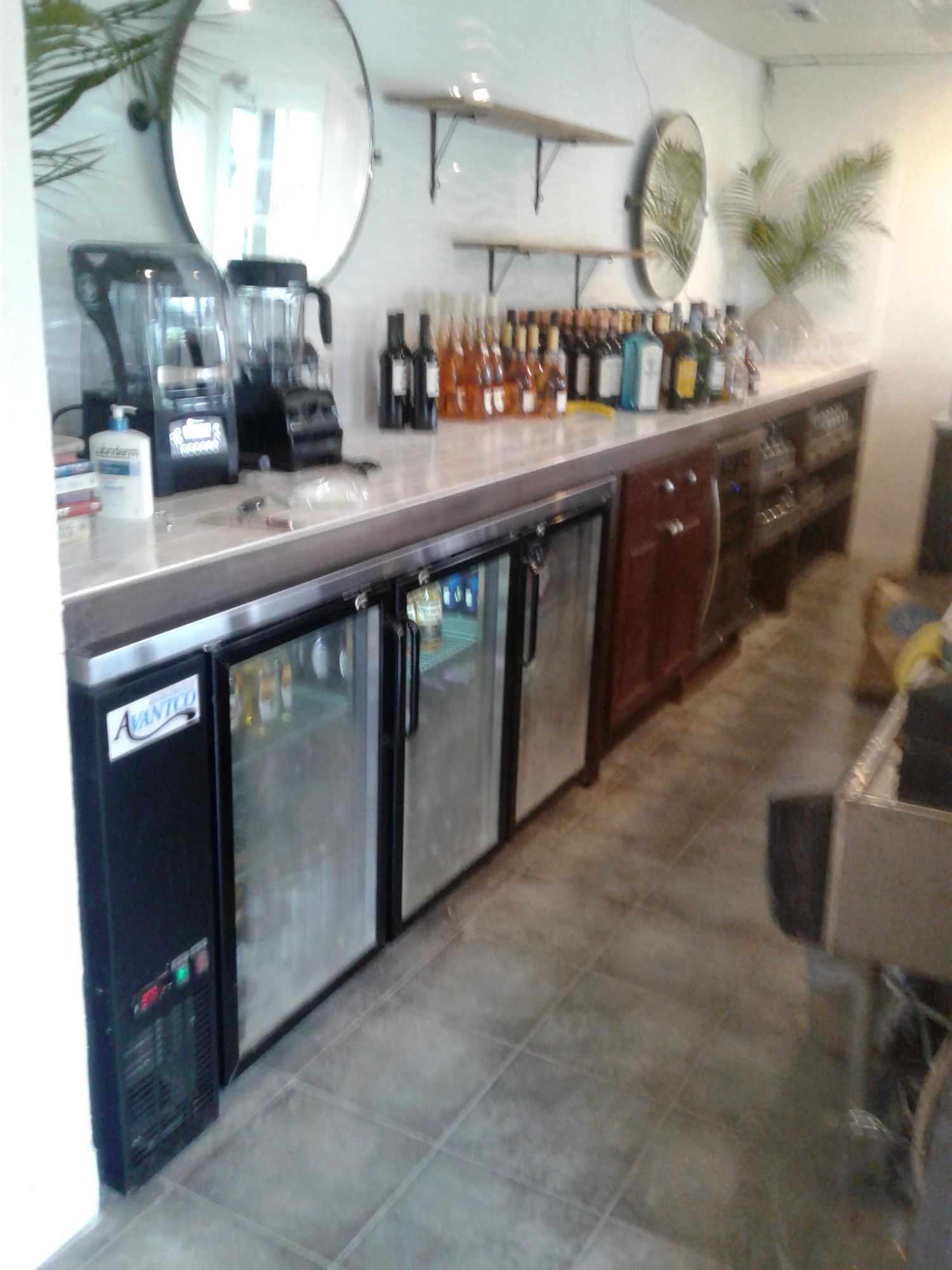 a kitchen with a blender and bottles on the counter