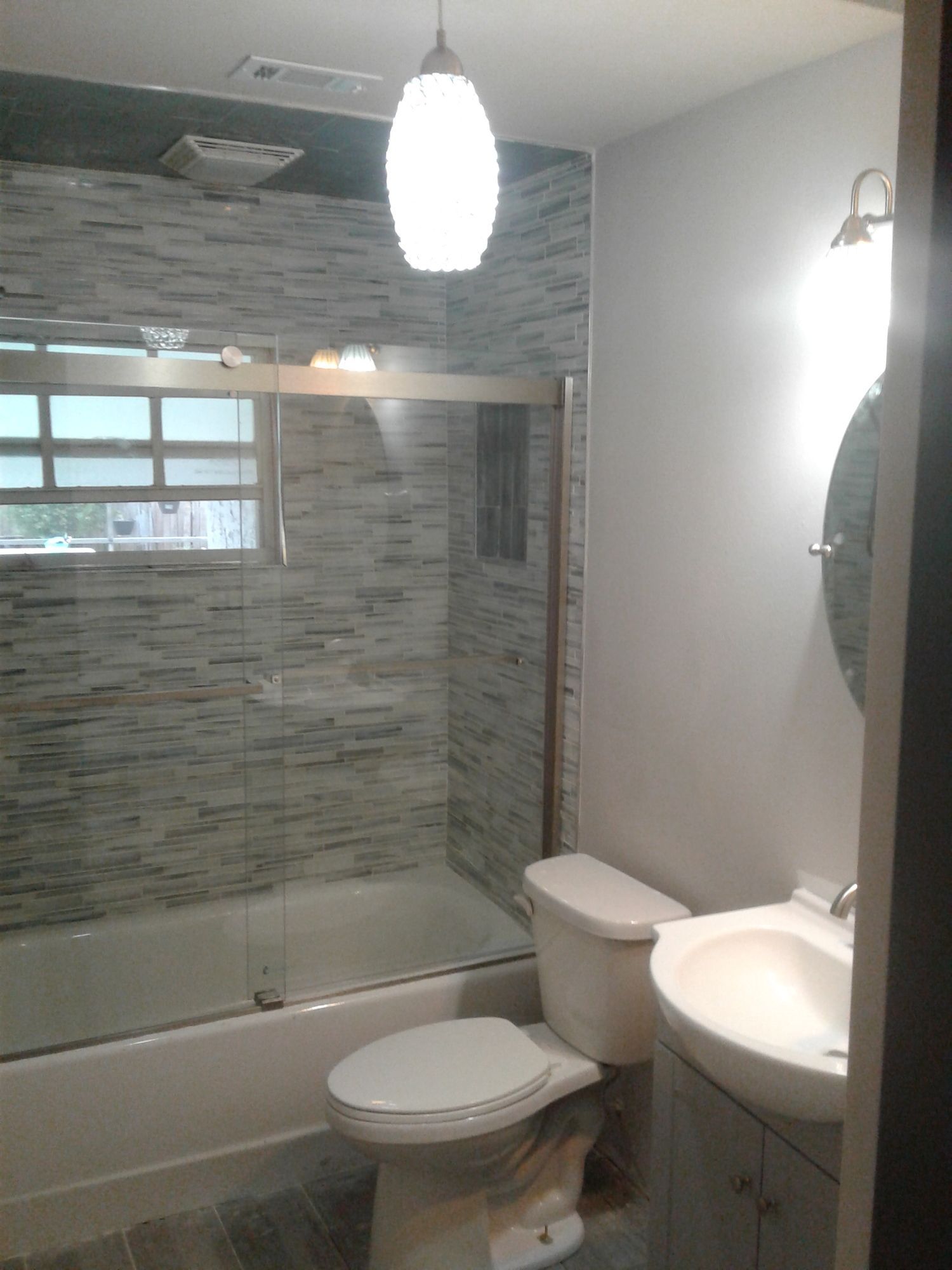 a bathroom with a toilet , sink and bathtub