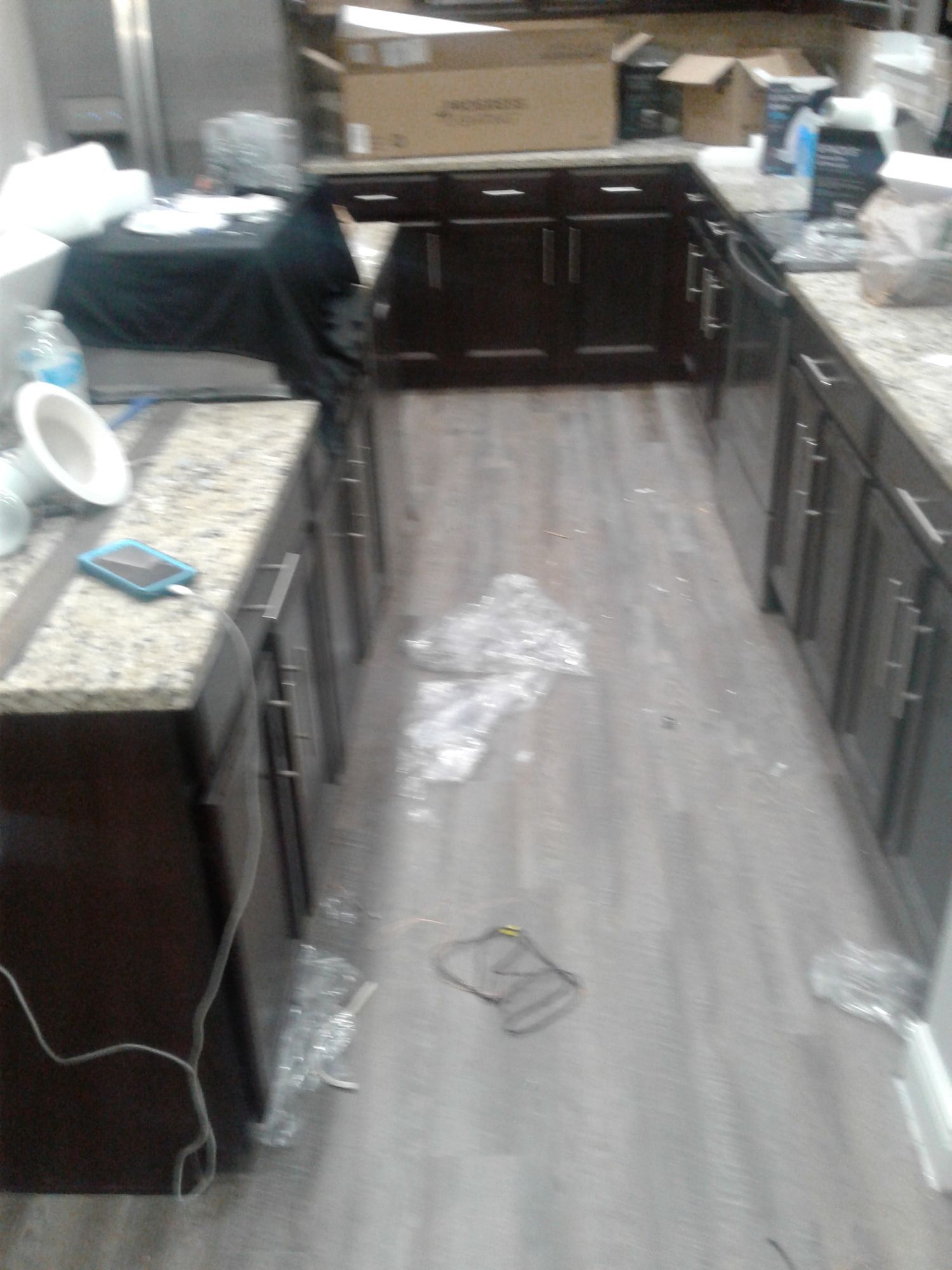 a kitchen with wooden cabinets and granite counter tops is being remodeled .