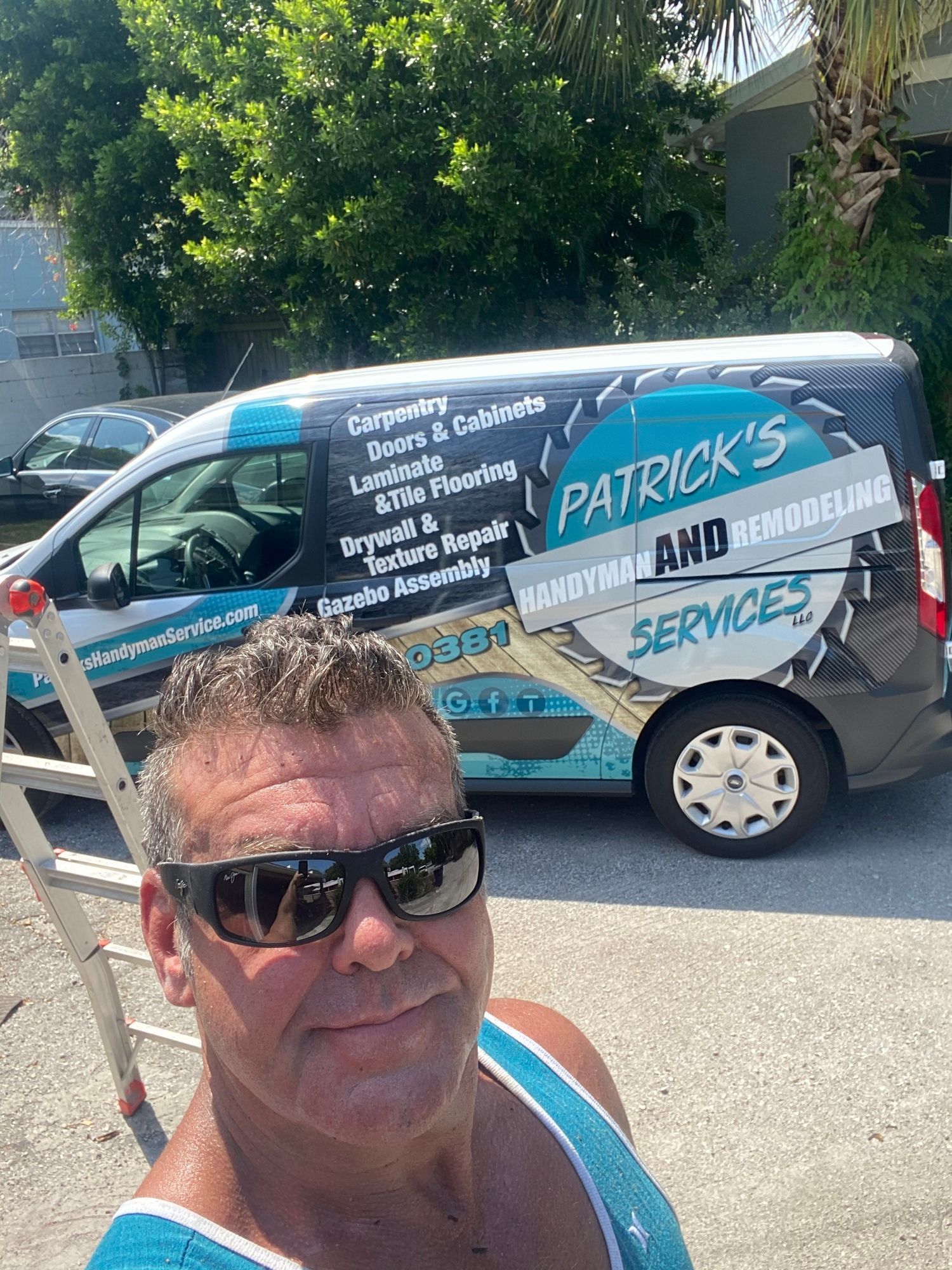a man wearing sunglasses is standing in front of a van .
