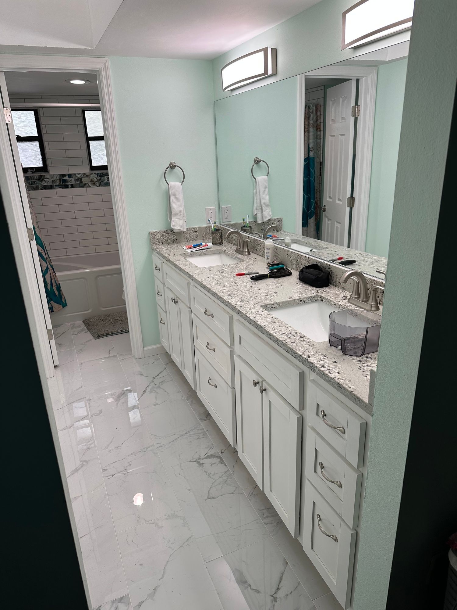 a bathroom with two sinks and a large mirror .and
