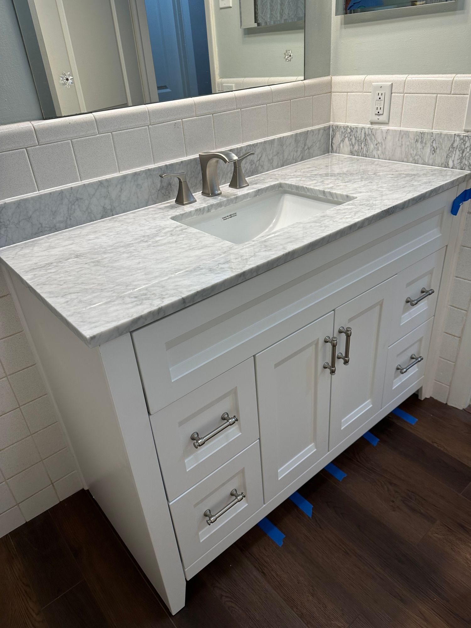 a bathroom vanity with a sink and a mirror .