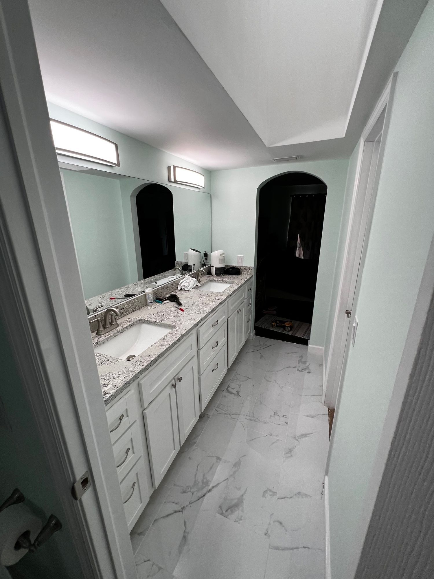a bathroom with two sinks and a large mirror .