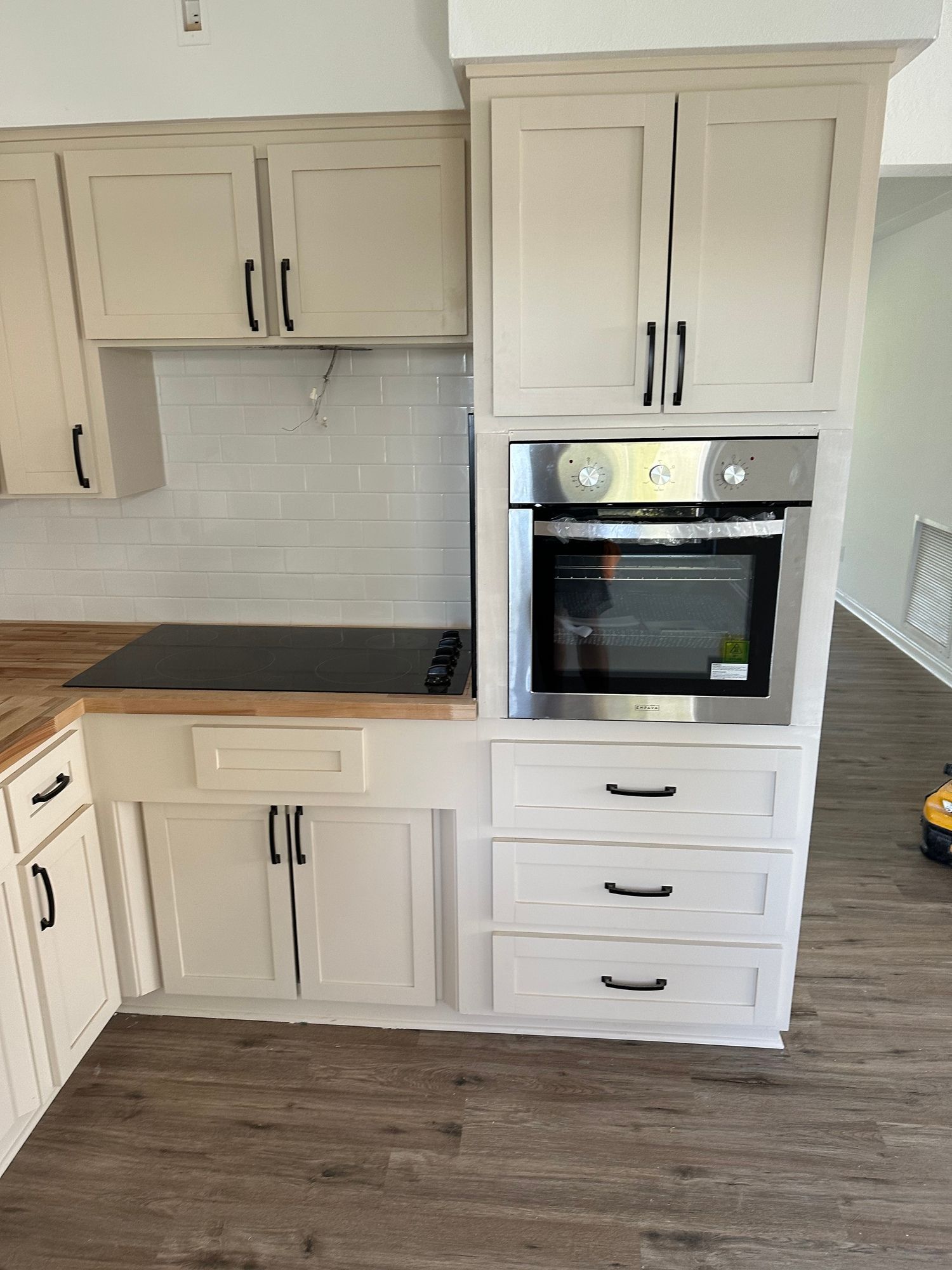 a kitchen with white cabinets and a stove top oven .