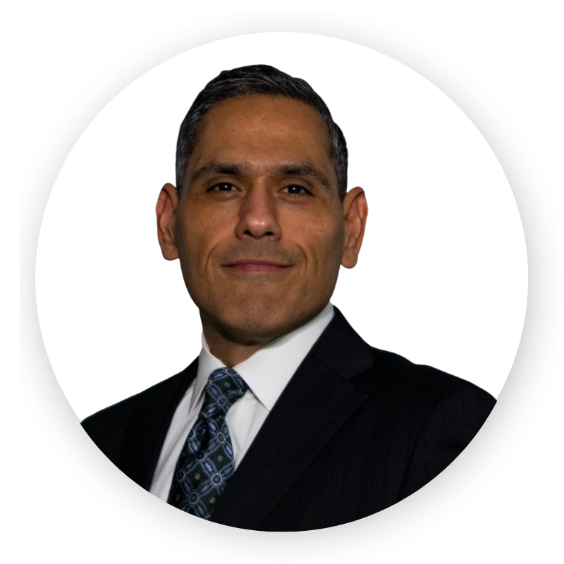 A man in a suit and tie is smiling for the camera