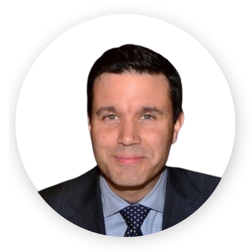 A man in a suit and tie is smiling for the camera