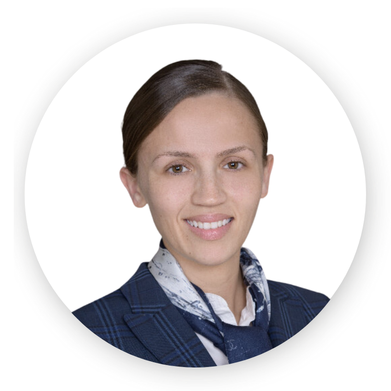 A woman in a suit and scarf is smiling in a circle