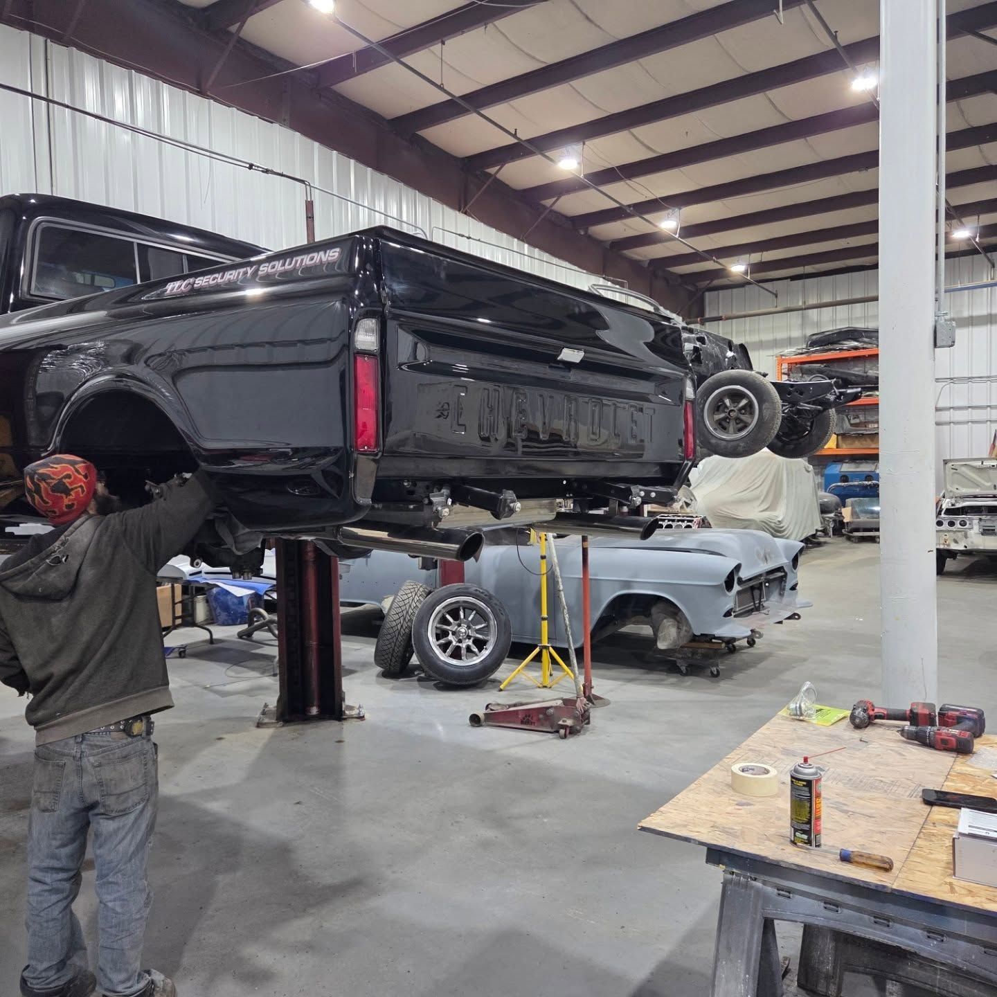 A man is working on a truck in a garage