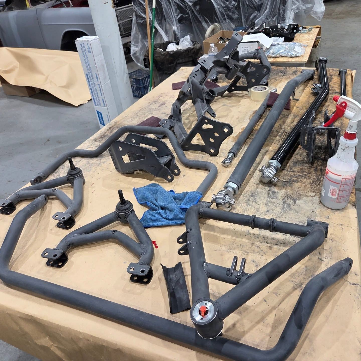 A table with a bunch of metal parts on it