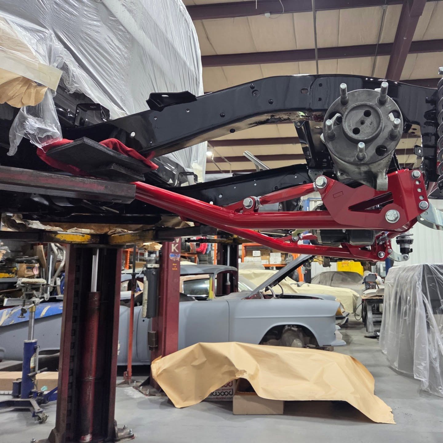 A car is sitting on a lift in a garage