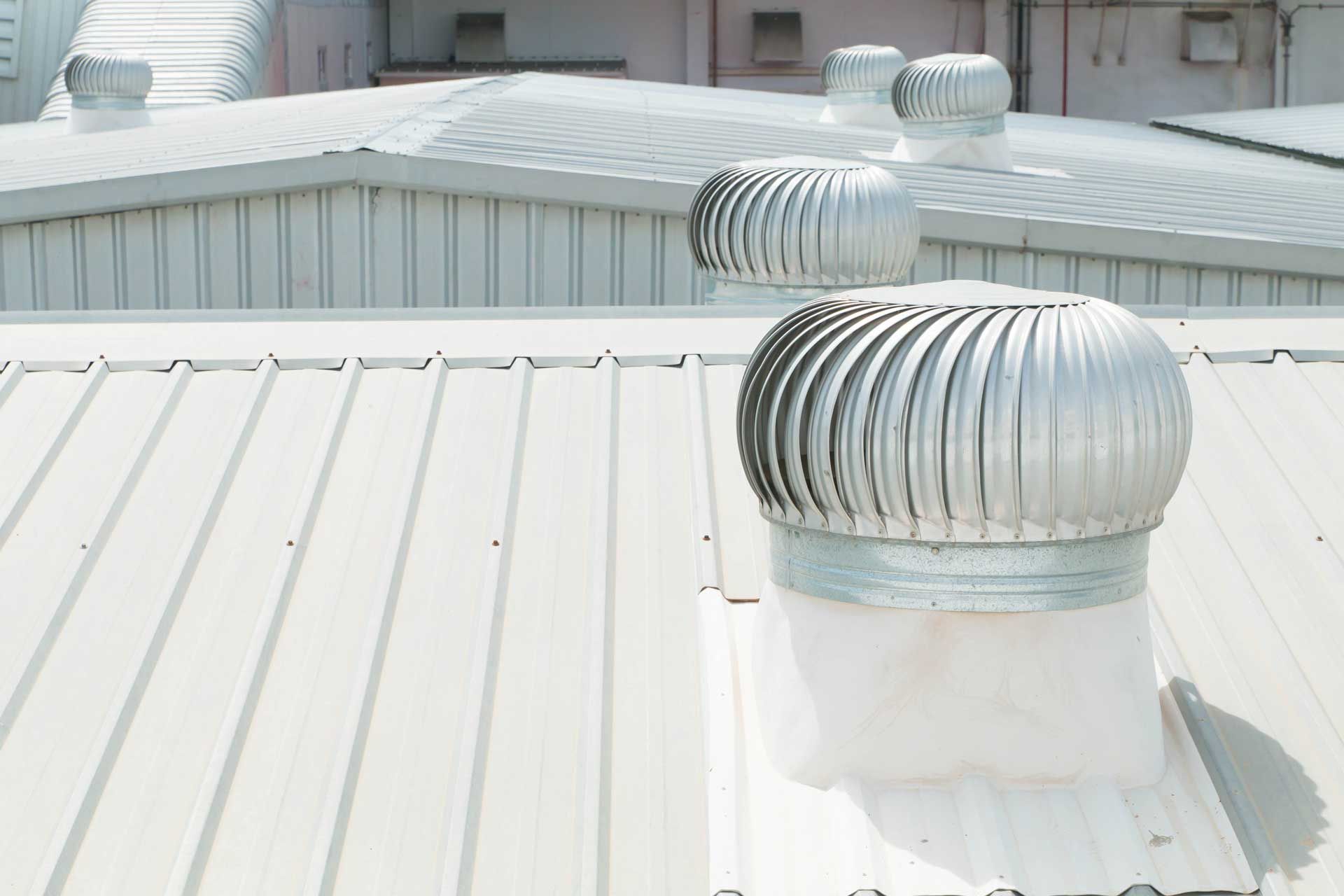 Metallic roof with several spinning ventilation turbines. Metallic roof with several spinning ventilation turbines.