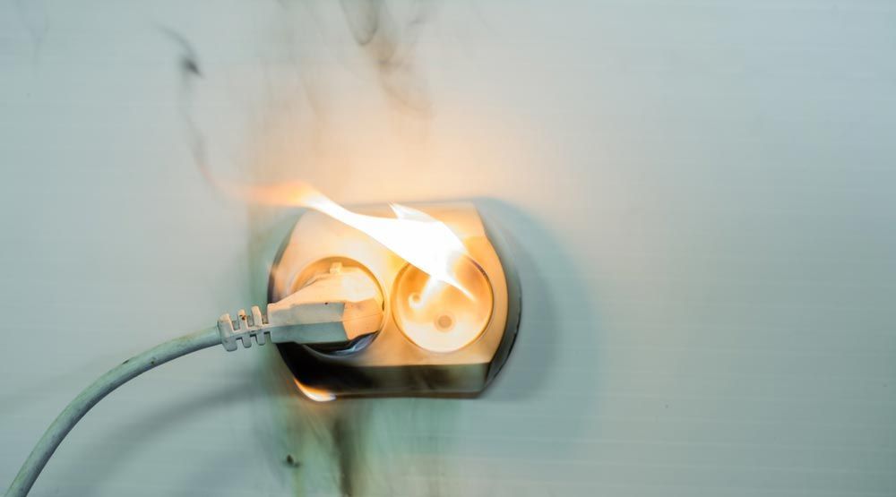A Fire Is Coming out Of a Plugged in Electrical Outlet — Peter Gow Electrical in Lismore, NSW