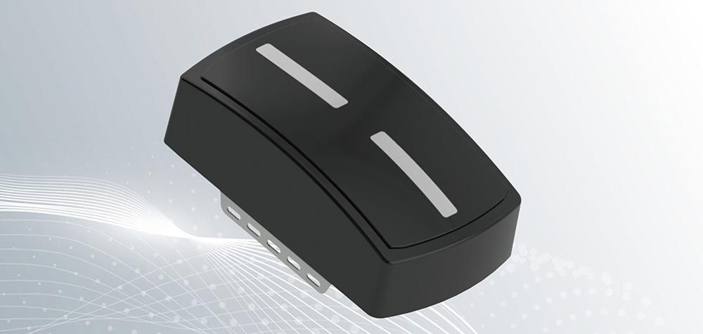 A black object with two white lines on it is sitting on a white surface.